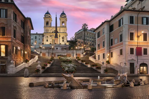 A quiet cobbled street in Rione Monti, near Hotel Colle Oppio on Via Panisperna, with the warm late-afternoon light typical of arrivals from Fiumicino.